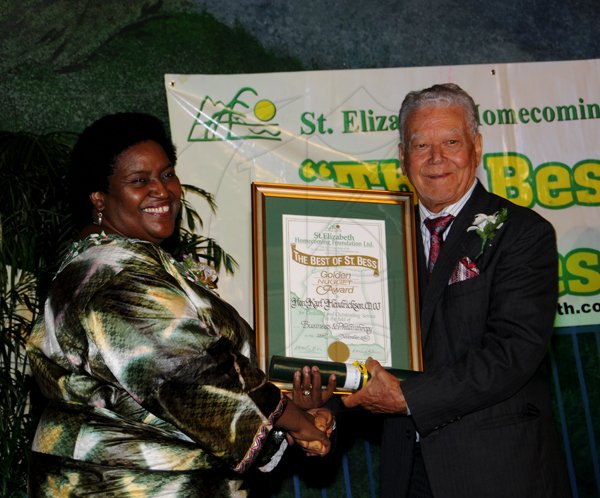 Winston Sill / Freelance Photographer
The St. Elizabeth Homecoming Foundation Limited (SEHF) 20th Annual Golden Awards Banquet, held at the Jamiaca Pegasus Hotel, New Kingston on Wednesday night November 28, 2012. Here are Donna Parchment Brown (left), Chairman, SEHF; and Oliver Jones (right), receiving on behalf of Karl Hendrickson, for  Business and Philanthropy.