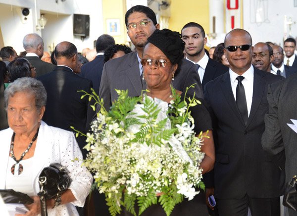 Rudolph Brown/Photographer
Charmaine Thompson, (centre) carry the urn of her mother along with Late Bunting sister Mercedes Ray, (left) Minister Peter Bunting, (right) and grandsons St. John Bunting, (second left) and Brent Bunting, (second right) after the funeral service for the late Pauline Bunting, Minister Peter Bunting mother at Sts. Peter and Paul Catholic Church on Monday, April 22, 2013