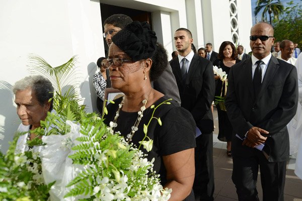 Rudolph Brown/Photographer
Charmaine Thompson, (forefront) carry the urn of her mother along with Late Bunting sister Mercedes Ray, (left) Minister Peter Bunting, (right) and grandsons St. John Bunting, (second left) and Brent Bunting, (second right) after the funeral service for the late Pauline Bunting, Minister Peter Bunting mother at Sts. Peter and Paul Catholic Church on Monday, April 22, 2013