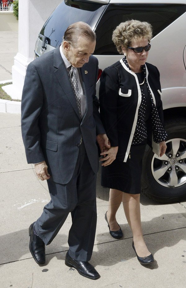 Gladstone Taylor/Staff Photographer
Former Prime Minister Edward Seaga and his wife Carla about to enter the Holy Trinity Cathedral on North Street in Central Kingston where the State Funeral for former Governor General Sir Howard Cooke was held yesterday.