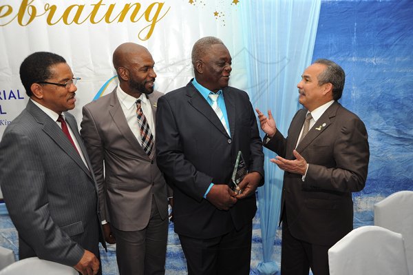 Ian Allen/Photographer
Carlos Urriola Tam (right), president, Caribbean Shipping Association, congratulates Dudley Goyley (second right) who was rewarded for long service to the Joint Industrial Council (JIC) for the Port of Kingston. Looking on are Grantley Stephenson (left), past president of the Shipping Association of Jamaica (SAJ) and Roger Hinds current president of the SAJ. Occasion was the 60th Anniversary Luncheon and Awards Ceremony of the JIC held on Wednesday at the Terra Nova Hotel in Kingston.