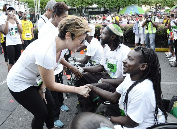 Rudolph Brown/Photographer
Tessanne Chin greets Alphanso Cunningham Sagicor Sigma Corporate Run at Emancipation Park in New Kingston on  Sunday, February 16, 2014