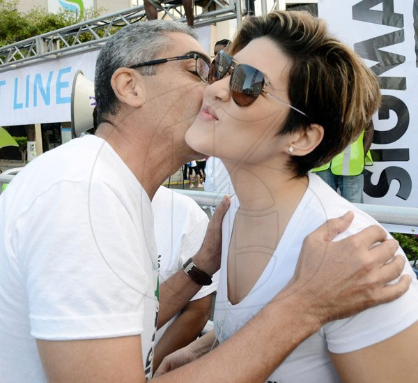 Rudolph Brown/Photographer
Richard Byles, President and CEO of Sagicor Life Jamaica puckers up to lay one on songstress Tessanne Chin at the Sagicor Sigma Corporate Run on Sunday.