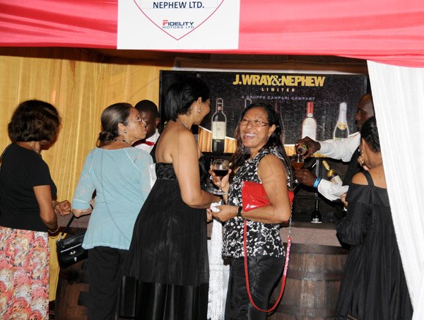 Winston Sill/Freelance Photographer
The Heart Foundation of Jamaica (HFJ) annual Simply Red Wine and Food Fundraising event, held on The Lawns of Jamaica House, Hope Road on Friday night September 27, 2013. Here is inside J. Wray and Nephew booth.