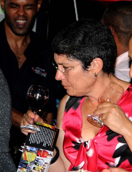 Winston Sill/Freelance Photographer
The Heart Foundation of Jamaica (HFJ) annual Simply Red Wine and Food Fundraising event, held on The Lawns of Jamaica House, Hope Road on Friday night September 27, 2013. Here is Catherine Handa having a sniff of her wine.