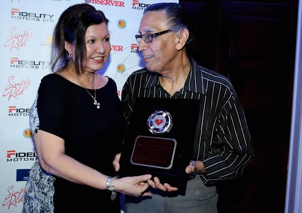 Winston Sill/Freelance Photographer
The Heart Foundation of Jamaica prersents the Media Launch of Simply Red, Wine and Food Festival, held at Millsborough Close on Tuesday night August 19, 2014. Here Dr. Knox Hagley (right), Chairman, Heart Foundation of Jamaica makes a Presentation to Martha Bonilia (left), wife of the Chilean Ambassador.