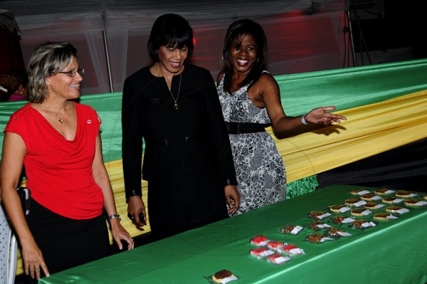 Winston Sill / Freelance Photographer
Heart Foundation of Jamaica  (HFJ) annual Wine and Food Festival, dubbed "Simply red and Wine Festival, held at Jamaica House Lawns on Friday night September 28, 2012. Here are Deborah Chen?? (left), Executive Director, HFJ; Prime Minister Portia Simpson-Miller (centre); and Stacy-=Ann Stoddart (right), inside the Jamaica Village booth.