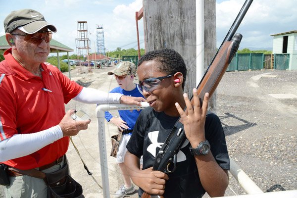 Rudolph Brown/Photographer
Khaleel Azam, (left) chat with D' Andre Simpson after shooting his target at Bernard Cridland Memorial Sporting Clay Shooting competition at the Jamaica Skeet Club on Sunday, October 27, 2013
