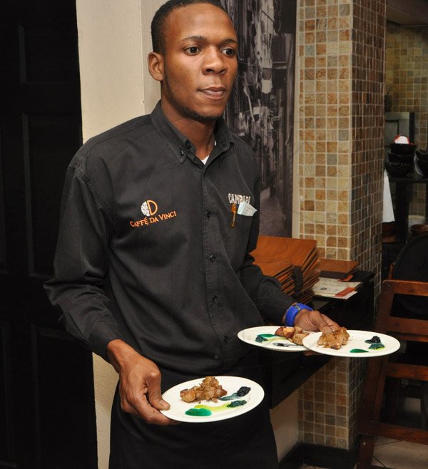 Jermaine Barnaby/Photographer
Caffe Da Vinci's waiter, Valdez Mighty as he prepares to serve a taste of the Something Blue Challenge to guest during RW at the cuisine on Monday, November 17, 2014.