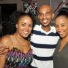 Jermaine Barnaby/Photographer
Cary Munoz  (center) is sandwiched by his wife Terese Heron-Munoz (left) and Yazmin Heron as they dined during RW Something Blue Challenge at usain bolt's tracks and records on Tuesday, November 18, 2014.