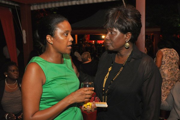 Jermaine Barnaby/Photographer
Digicel's Trisha Williams-Singh (left) and  Miss Jamaica world 1978, Joan McDonald at Spain's National Day at the Embassy Residence – I-B Norbrook Road on Thursday, October 9, 2014.