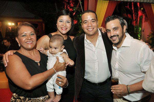 Jermaine Barnaby/Photographer
Spain's National Day at the Embassy Residence – I-B Norbrook Road on Thursday, October 9, 2014.

From left: Milagros Gonzalez, baby Luis Alfrefo Stefan, Alicia la Paix, Alfredo Stefan from the Embassy of the Dominican Republic, and Alejandro Martin share a perfect picture group moment