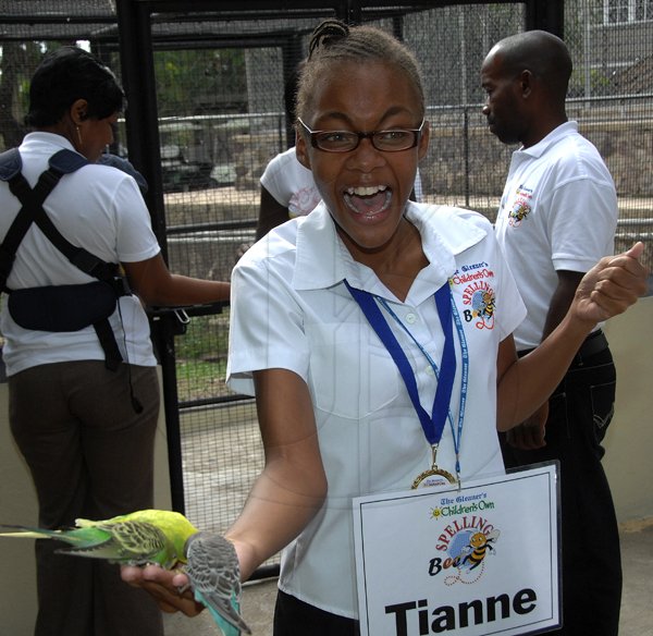 Ian Allen /  Photographer
Tianne Barclay of Ardenne High and champion Girl in the just concluded Gleaner Spelling Bee competition screamed in delight when Budgerigar ate from her hand while on a visit to the Hope Zoo as part of the prize.