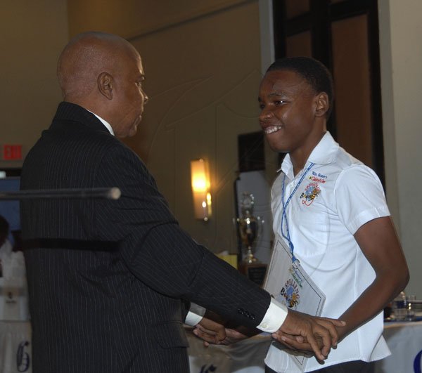 Ian Allen /  Photographer
Reverend Glen Archer left, celebrates with Gifton Wright  the 2012 Gleaner Spelling Bee winner shortly after he won the  finals at the Jamaica Pegasus hotel in Kingston.