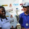 Norman Grindley/Chief Photographer
President of Proven Wealth Chorvelle Johnson (left) presents the championship school trophy to Chad Ziadie, captain of Hillel Academy at ClayFeva, first event of the Proven  SportsFeva 2012, held at the Jamaica Skeet club in Portmore, St Catherine November 4, 2012.