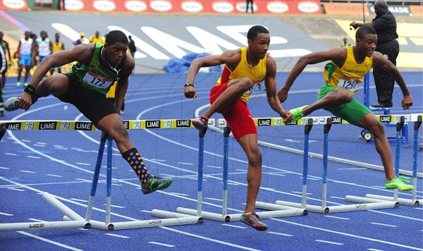 Ian Allen/Photographer
Jordon Chin right of St.Jago, Jaheel Hyde centre of Wolmers Boys and Seanie Selvin of Calabar together at he first hurdle in semi-finals one of the Class 2 Boys 110 metre hurdles on Day Four of the 2013 Boys and Girls Atlethics Championships.