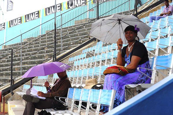 Ian Allen/Photographer
Patrons at the 2013 Boys and Girls atlethics Championships had their umbrellas out early on the fourth day during a light drizzle.