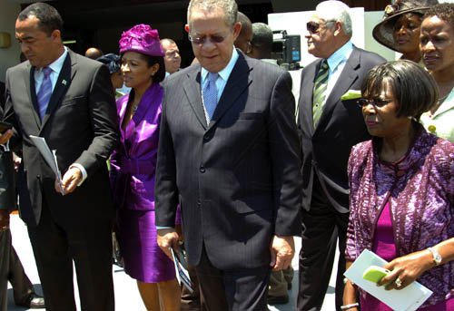 Norman Grindley/Chief Photographer
Prime Minister Bruce Golding (centre) leads his party into Gordon House. Walking with him are (from left) Dr Christopher Tufton, wife Neadene Tufton and Lorna Golding. Transport Minister Mike Henry is in the background.

Budget 2011-2012.