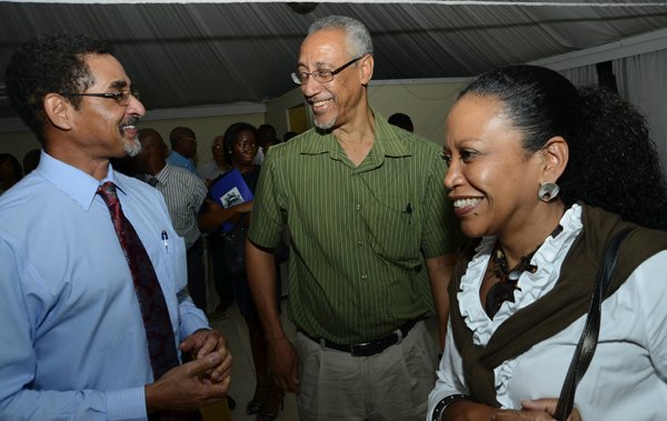 Rudolph Brown/Photographer
Charles Ross, (left) CEO of Sterling Asset Management in discussion with Dennis Welds and his wife Andrey at the Sterling Asset Management Investor Briefing at the Terra Nova Hotel in Kingston on Thursday, September 27-2012