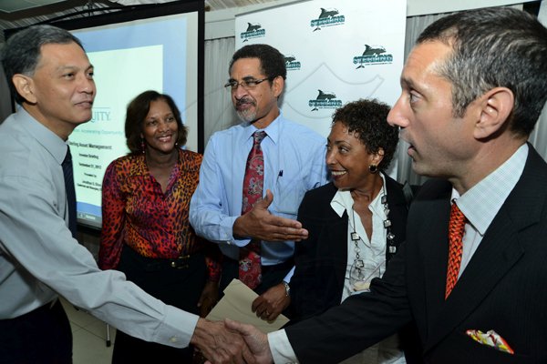 Rudolph Brown/Photographer
Charles Ross, (centre) CEO of Sterling Asset Management in discussion with from left Claudette and Stephen Medhoo, Jennifer Cheesman and Jonathan Blue, Chairman and Managing Director , Blue Equity at the Sterling Asset Management Investor Briefing at the Terra Nova Hotel in Kingston on Thursday, September 27-2012
