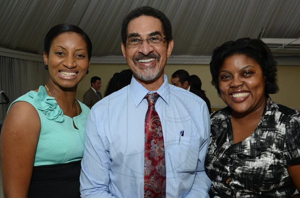 Rudolph Brown/Photographer
Charles Ross,  CEO of Sterling Asset Management pose with Nadia Mahaber, (left) and Tavia Dunn at the Sterling Asset Management Investor Briefing at the Terra Nova Hotel in Kingston on Thursday, September 27-2012