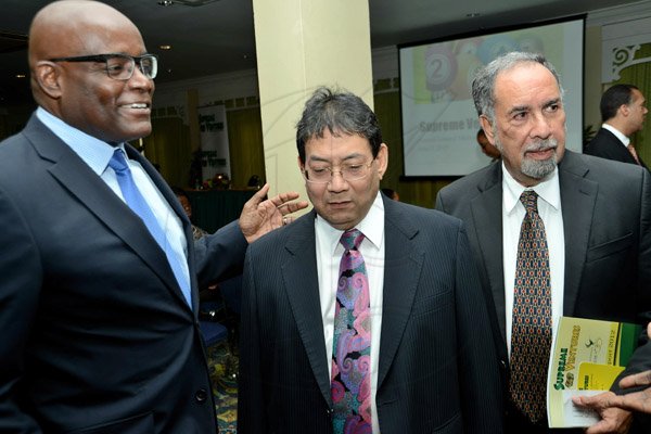 Rudolph Brown/Photographer
Business Desk
Paul Hoo, (centre) Chairman chat with Brian George,(left) President and CEO and Ian Levy, (right) Board Director at the Supreme Ventures Ltd AGM at Knutsford Court Hotel in Kingston on Monday, June 3, 2013