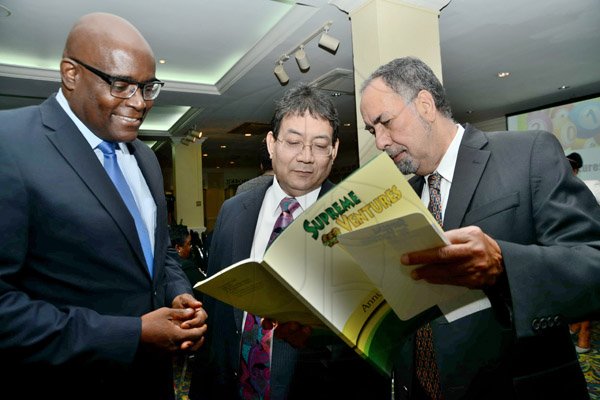 Rudolph Brown/Photographer
Business Desk
Paul Hoo, (centre) Chairman looking at the annual report with Brian George,(left) President and CEO and Ian Levy, (right) Board Director at the Supreme Ventures Ltd AGM at Knutsford Court Hotel in Kingston on Monday, June 3, 2013