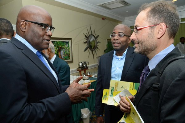 Rudolph Brown/Photographer
Business Desk
Brian George,(left) President and CEO chat with Directors Georgios Sampson (right) and Curtis Martin at the Supreme Ventures Ltd AGM at Knutsford Court Hotel in Kingston on Monday, June 3, 2013