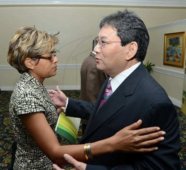 Rudolph Brown/Photographer
Business Desk
Deika Morrison greets Paul Hoo, Chairman of Supreme Ventures at the Supreme Ventures Ltd AGM at Knutsford Court Hotel in Kingston on Monday, June 3, 2013