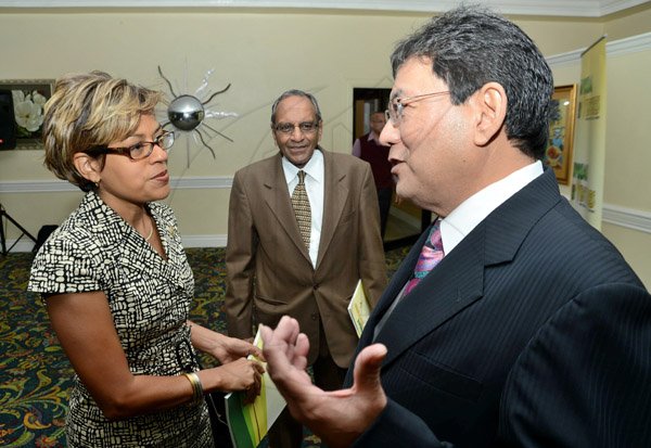 Rudolph Brown/Photographer
Business Desk
Deika Morrison chat with Paul Hoo,(left) Chairman of Supreme Ventures and Sushil Jain at the Supreme Ventures Ltd AGM at Knutsford Court Hotel in Kingston on Monday, June 3, 2013