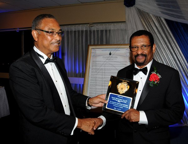 Winston Sill/Freelance Photographer
The Association of Surgeons in Jamaica (ASJ) Annual Awards Banquet, held at the Jamaica Pegasus Hotel, New Kingston on Saturday night May 18, 2013. Here Dr. Patrick Bhoorasingh (left) presents awardee  Dr. Trevor McCartney (right) with the Citation and a Plaque.