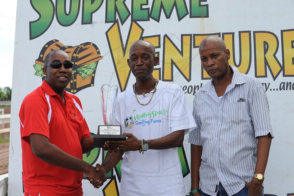 Ian Allen/Photographer
Presentation to the handlers of Super Heritage for winning the (5th) Supreme Ventures "Games People Love to Play" Trophy at Caymanas Park on Boxing Day.