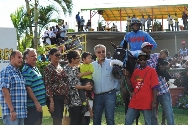 Ian Allen/Photographer
Jockey L.Steadman aboard Perfect Neighbour been led to the winners enclosurer after winning the (7th) 53rd Running of the Harry Jackson Memorial Cup at Caymanas Park on Boxing Day.