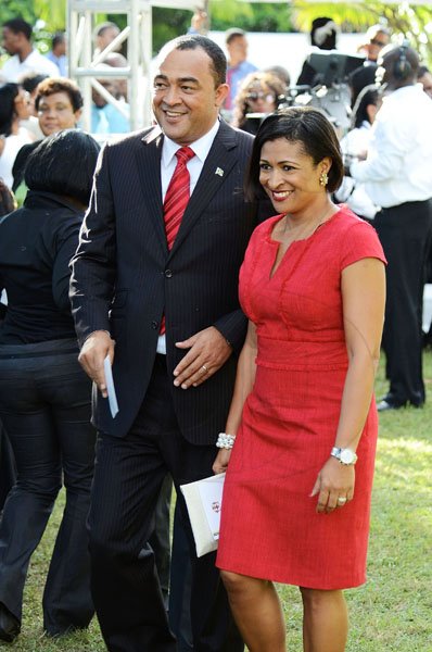 Rudolph Brown/Photographer
Industry and Commerce Minister Dr Christopher Tufton ties in with his wife Neadene's red dress.

***************************************************************************** wardrobes .

 Andrew Holness swearing in as new Prime Minister at King's House on Sunday, October 23-2011