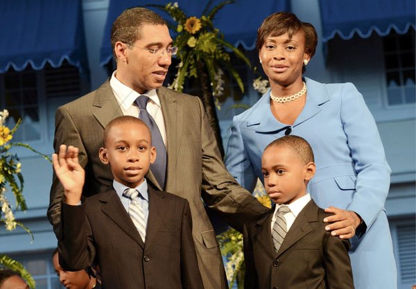 Rudolph Brown/Photographer
Prime Minister Andrew Holness and his wife Juliet watch as their sons, Adam (left) and Andrew Jr greet those gathered at the swearing-in ceremony.