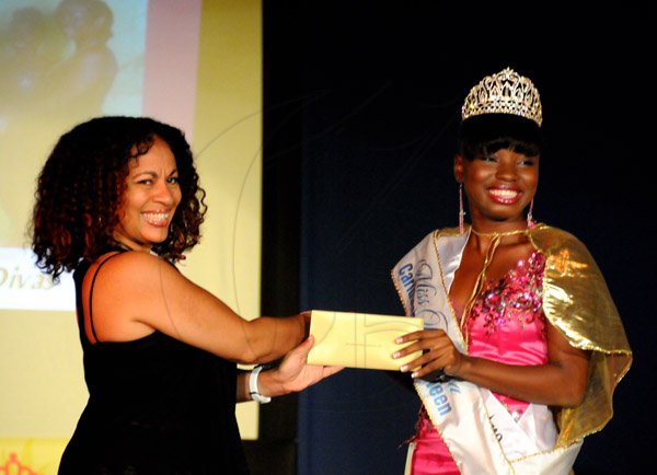 Winston Sill/Freelance Photographer
Miss Jamaica Caribbean Talented Teen 2013 show and coronation, held at Louise Bennett Garden Theatre, Hope Road on Sunday night September 1, 2013. Here Diane Wilson (left), Recruitment and Enrollment Manager of University College of the Caribbean presents a scholarship to the winner Josselle Fisher (right).