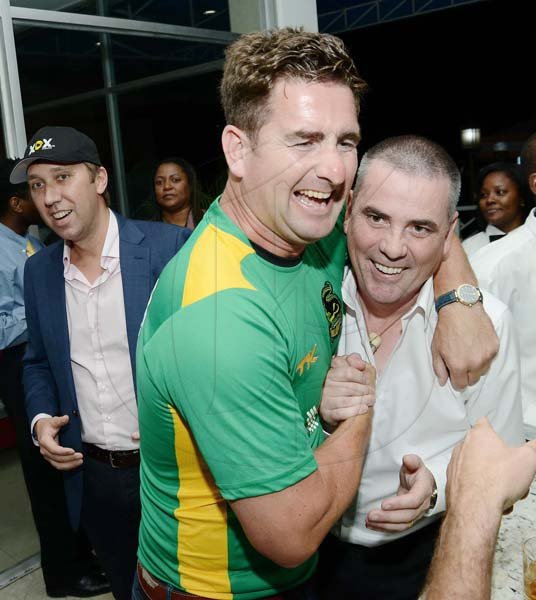 Rudolph Brown/ Photographer
Paul Ryan, (left) greets Locky Mulholland, managing director of the XOX brand in a head lock at a welcome reception hosted by XOX for members of the Jamaica Tallawahs cricket team at the Pegasus on Wednesday.