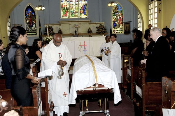 Winston Sill / Freelance Photographer
Reverend Father Franklyn Jackson gives the final blessing during the mass of resurrection for Joseph Badia Hanna, held at The Church of St Margaret on Old Hope Road in St Andrew yesterday.