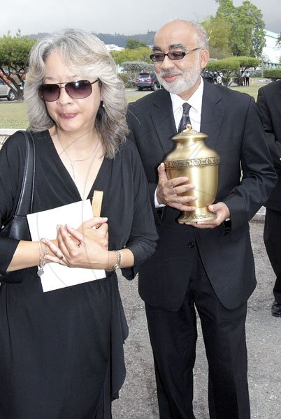 Ian Allen/Photographer
Charmaine Burrowes left and her brother Justice Andrew Rattray right with the Urn with the remains of their father Carl Rattray after the Official Thanksgiving Service at the University Chapel, University of the West Indies, Mona on tuesday.