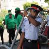 Jermaine Barnaby/Freelance Photographer
JLP supporters look as police carrying barricades to set up the state opening of Parliament at Gordon House on Thursday April 14, 2016.