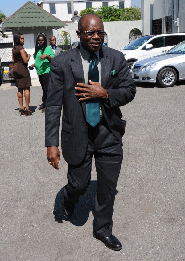 Jermaine Barnaby/Freelance Photographer
Everald Warmington making his way into the Bitu compound just before the state opening of Parliament at Gordon House on Thursday April 14, 2016.