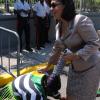 Jermaine Barnaby/Freelance Photographer
A supporter cleaning the shoe of Shahine Robinson as she arrived for the state opening of Parliament at Gordon House on Thursday April 14, 2016.