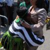 Jermaine Barnaby/Freelance Photographer
A supporter tries to lift of Shahine Robinson as she arrived for the state opening of Parliament at Gordon House on Thursday April 14, 2016.