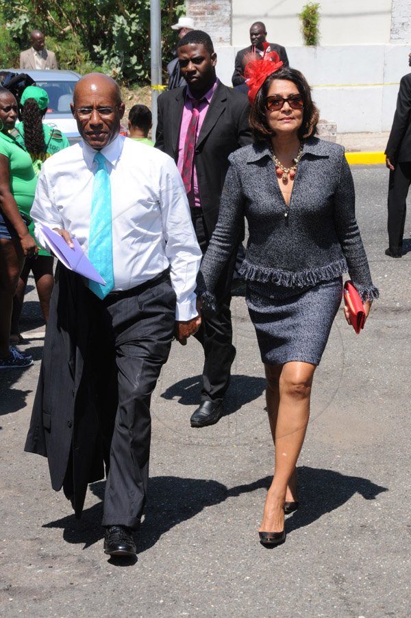 Jermaine Barnaby/Freelance Photographer
Aubyn Hill (left0 and his wife making their way to the state opening of Parliament at Gordon House on Thursday April 14, 2016.
