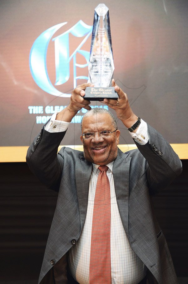 Jermaine Barnaby/Photographer<\n>Dr. Peter Phillips hold aloft the Gleaner Honour awards for man of the year held at the Pegasus hotel on Monday January 25, 2016.