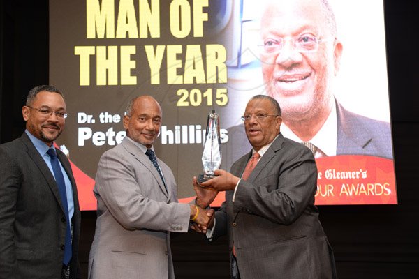 Jermaine Barnaby/Photographer
Peter Phillips (right) accepting his award from Douglas Oraine while Christopher Barnes (left) looks on at the Gleaner Honour awards held at the Pegasus hotel on Monday January 25, 2016.