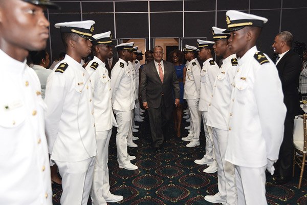 Jermaine Barnaby/Photographer<\n>Man of the Year Peter Phillips walks through a guard of Maritime at the Gleaner Honour awards held at the Pegasus hotel on Monday January 25, 2016.