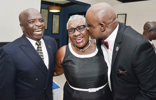 Rudolph Brown/ Photographer
Vivian Crawford (left) looks on with a huge smile while awardee Fritz Pinnock greets fellow awardee Marva Bernard with a kiss.