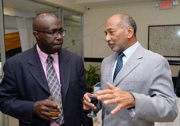 Jermaine Barnaby/Photographer
Douglas Oraine (right) making a point to gary Allen at the Gleaner Honour awards held at the Pegasus hotel on Monday January 25, 2016.