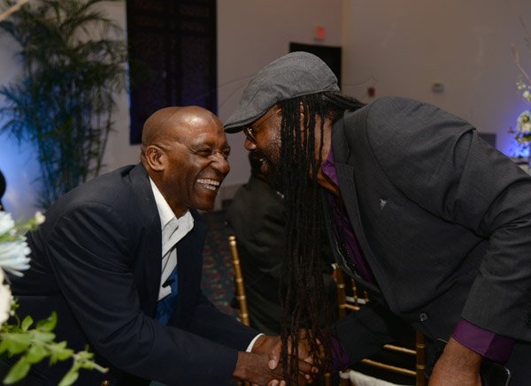 Jermaine Barnaby/Photographer
Tony Rebel (right) greeting Robert Bryan at the Gleaner Honour awards held at the Pegasus hotel on Monday January 25, 2016.